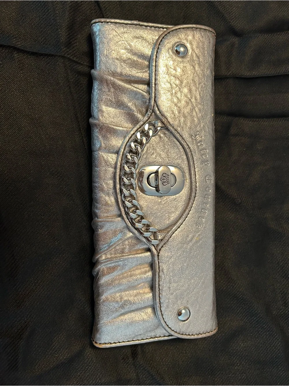 Juicy Couture Silver Leather Woman’s Clutch/Wallet with silver chain trim.
